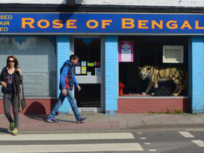 BOSTON, UK, UNITED KINGDOM - 2018/06/18: People walk past an Indian restaurant in the town centre of Boston, Lincolnshire. The Lincolnshire town recorded the highest leave vote in the 2016 referendum with 75.65% of the population voting to leave the European Union. Boston also has the highest proportion of eastern …