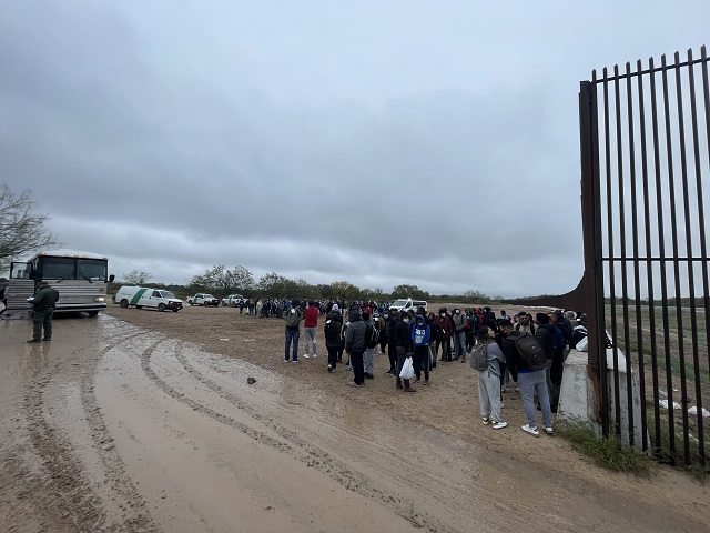 A large group of more than 200 migrants wait in the cold near Eagle Pass, Texas, for Border Patrol buses. (Randy Clark/Breitbart Texas)