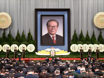 People take part in the public memorial service for China's former leader Jiang Zemin at the Great Hall of the People in Beijing on December 6, 2022. - China OUT (Photo by CNS / AFP) / China OUT (Photo by -/CNS/AFP via Getty Images)