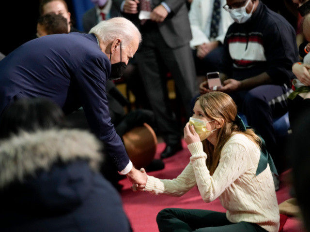 President Joe Biden shakes hands with a child at Children's National Hospital after f