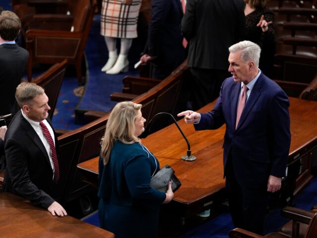 House Minority Leader Kevin McCarthy of Calif., right, arrives on the House floor before U