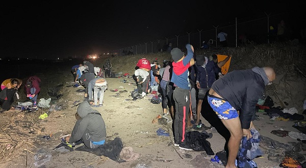 A large group of migrants discard clothing along the Texas bank of the Rio Grande after crossing from Mexico. (U.S. Border Patrol/Del Rio Sector)