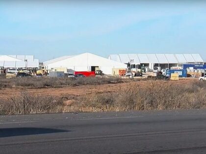 CBP contractors work to complete a new soft-sided migrant processing center near El Paso. (KVIA Video Screenshot)