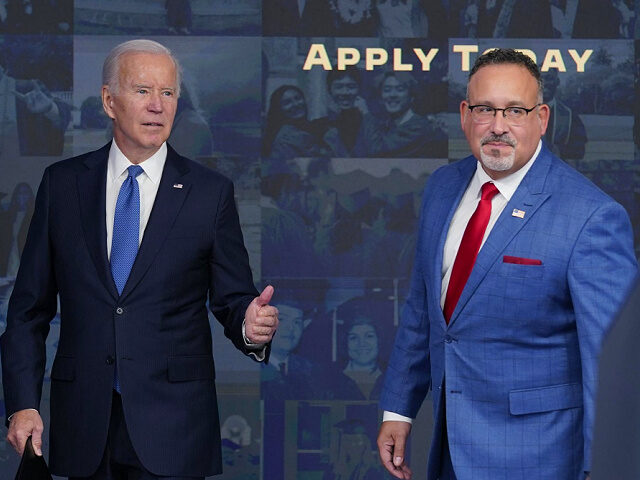 President Joe Biden answers questions with Education Secretary Miguel Cardona as they leave an event about the student debt relief portal beta test in the South Court Auditorium on the White House complex in Washington, Monday, Oct. 17, 2022. (AP Photo/Susan Walsh)