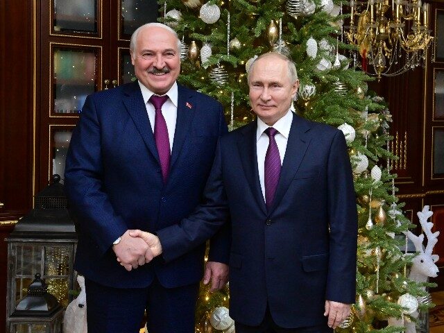 Russian President Vladimir Putin, right, and Belarusian President Alexander Lukashenko pos