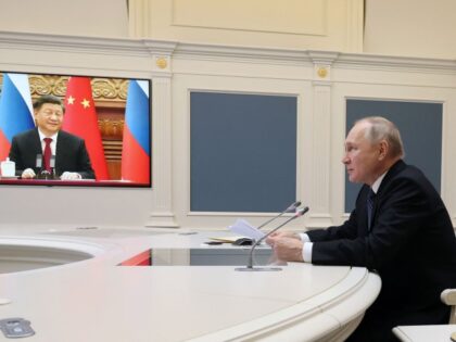 TOPSHOT - Russian President Vladimir Putin holds a meeting with Chinese President Xi Jinping via a video link at the Kremlin in Moscow on December 30, 2022. - Russian leader told his Chinese counterpart on December 30 he was keen to ramp up military cooperation and hailed the two countries' …