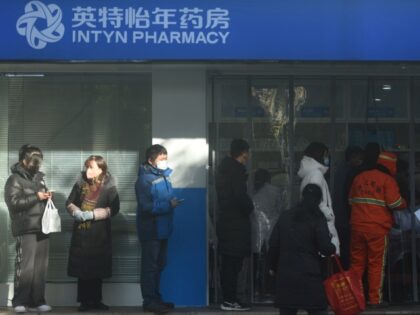 HANGZHOU, CHINA - DECEMBER 19, 2022 - People line up to buy COVID-19 antigen reagents at a pharmacy in Hangzhou, east China's Zhejiang province, Dec 19, 2022. (Photo credit should read CFOTO/Future Publishing via Getty Images)
