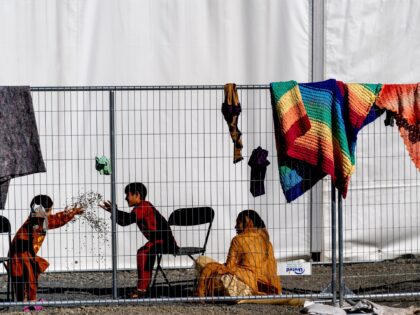 Children play with stones at an Afghan refugees camp on Joint Base McGuire Dix Lakehurst,