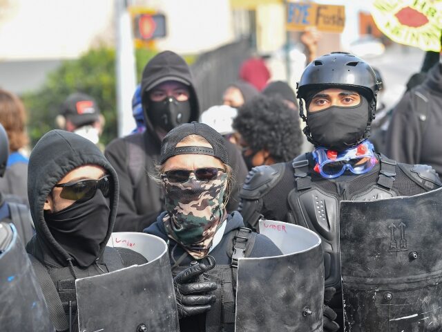 ATLANTA, GA - DECEMBER 12: Antifa members gather behind protective shields during a Stop T