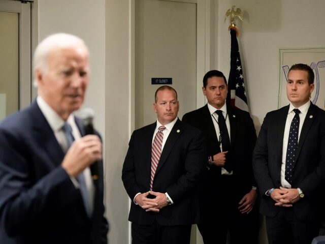 WASHINGTON, DC - OCTOBER 24: Members of the U.S. Secret Service stand watch as U.S. President Joe Biden speaks at the headquarters of the Democratic National Committee (DNC) October 24, 2022 in Washington, DC. Biden spoke to staff and volunteers about the midterm elections, which are now two weeks away. …