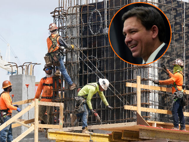 FILE - Construction workers fasten the frame of a new building, Monday, May 3, 2021, in Mi