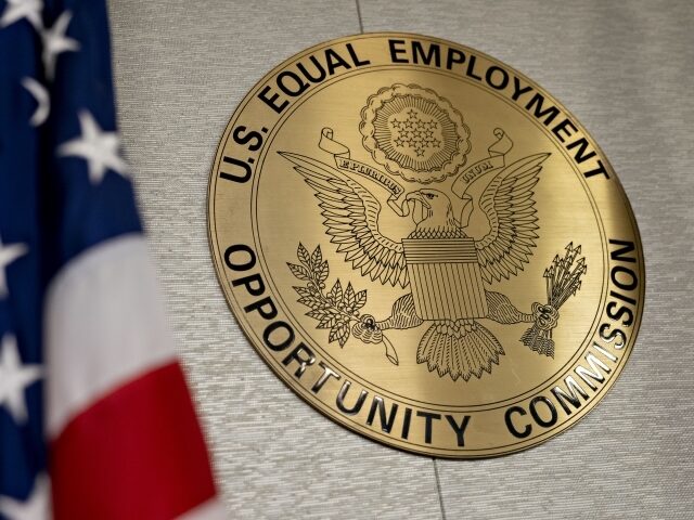The Equal Employment Opportunity Commission (EEOC) seal hangs inside a hearing room at the