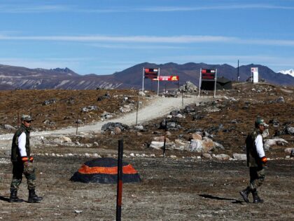 FILE - In this Sunday, Oct. 21, 2012, file photo, Indian army soldiers walk along the line of control at the India- China border in Bumla in the northeastern Indian state of Arunachal Pradesh. The Indian army said Saturday, Sept. 12, 2020, that China has released five Indian nationals who …