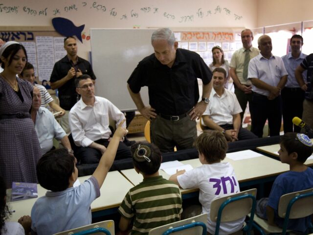 Israeli Prime Minister Benjamin Netanyahu visits a classroom on the first day of the Israe
