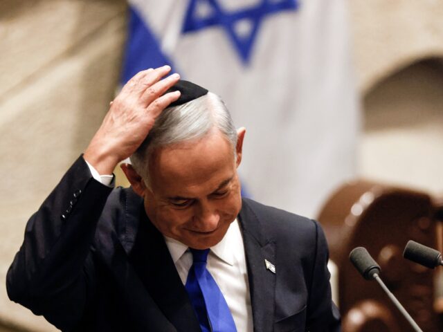 Israeli Prime Minister-designate Benjamin Netanyahu adjusts his skull cap after speaking a