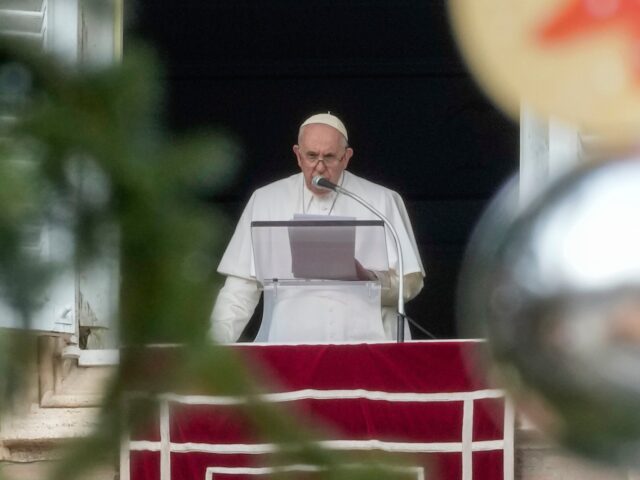 Pope Francis, framed by decorations of the Vatican Christmas tree, delivers his speech as