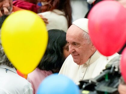 Pope Francis greets children at the end of an audience with children assisted by the Santa Marta dispensary in the Paul VI Hall, at the Vatican, Sunday, Dec. 18, 2022. Pope Francis turned 86 on Dec.17. (AP Photo/Andrew Medichini)