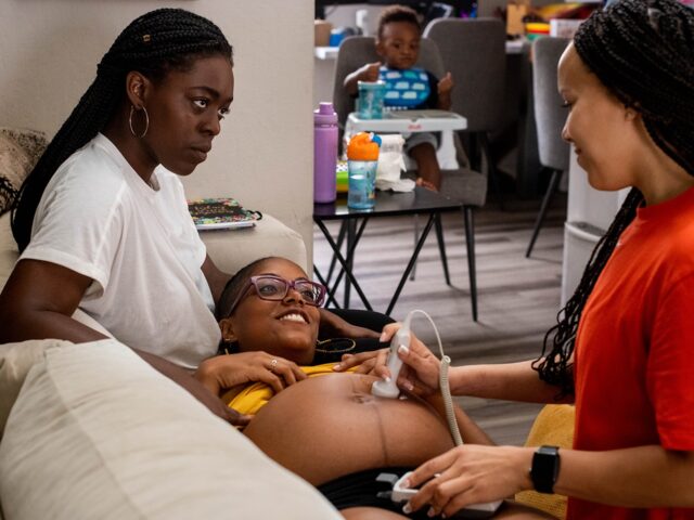 Fountain Valley, CA - June 29:Midwife Angie Miller listens to the heart beat of MyLin Stok