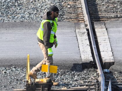 FILE - A rail worker switches a track for a Locomotive in the Selkirk rail yard, Wednesday
