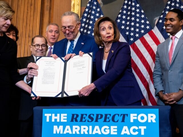 UNITED STATES - DECEMBER 8: Speaker of the House Nancy Pelosi, D-Calif., and Senate Majority Leader Charles Schumer, D-N.Y., conduct a bill enrollment ceremony after the House passed the Respect for Marriage Act in the U.S. Capitol on Thursday, December 8, 2022. The bill mandates federal protection for same-sex marriages. …