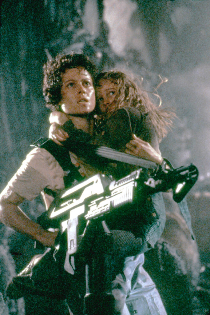American actresses Sigourney Weaver and Carrie Henn on the set of Aliens, written and directed by Canadian James Cameron. (Photo by Twentieth Century Fox Film Corporation/Sunset Boulevard/Corbis via Getty Images)