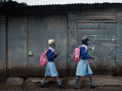 Students wearing masks walk to school in Kenya (AFP)