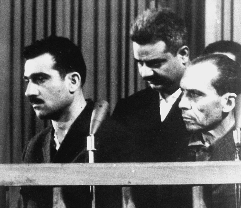 Picture dated 09 May 1965 shows Israeli spy Elie Cohen (L) and two other unidentified co-defendants, during their trial in Damascus, ten days before his execution. Israel wants Syria to return Cohen's remains as a confidence-building gesture in the framework of the peace talks between the two countries which resumed last month after a nearly four-year break. (Photo credit should read AFP via Getty Images)
