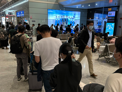 Passengers prepare to board a flight at the airport in north-central China's Jiangxi province on Nov. 1, 2022. The Chinese government said Tuesday, Dec. 27 it will start issuing new passports as it dismantles anti-virus travel barriers, setting up a potential flood of millions of tourists out of China for …