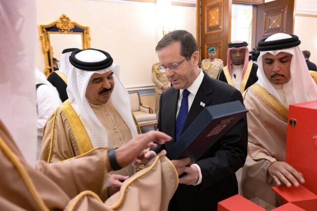 Bahrain's King Hamad bin Isa al-Khalifa receives a gift from Israeli President Isaac Herzo