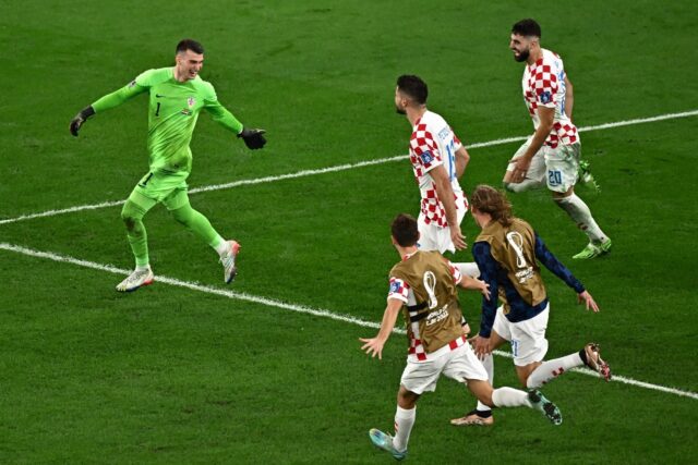 Croatia players run to celebrate with goalkeeper Dominik Livakovic after their stunning pe
