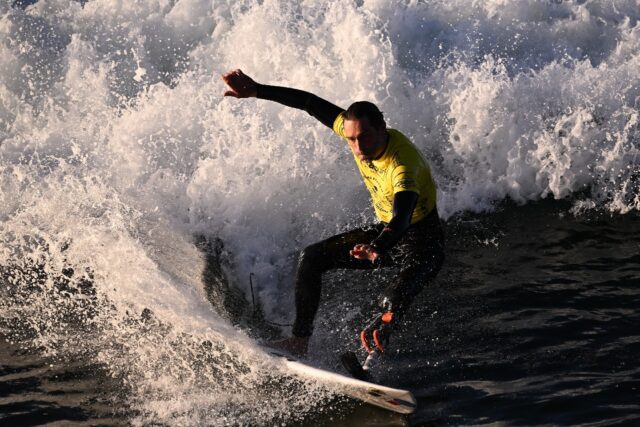 French athlete Eric Dargent, who has a prosthetic foot, surfs in his heat on the second da