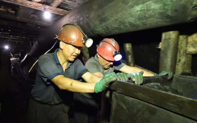 Miners working outside the town of Suluktu in ex-Soviet Kyrgyzstan are hopeful amid an upt