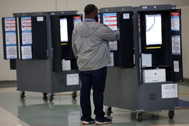 A voter casts his ballot in the US Senate runoff election in Atlanta, Georgia