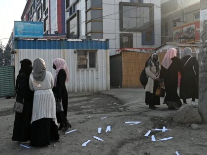 Afghan female university students walk on their on way back home past a private university in Kabul on December 21, 2022. - Afghanistan's Taliban rulers have banned university education for women nationwide, provoking condemnation from the United States and the United Nations over another assault on human rights. (Photo by …