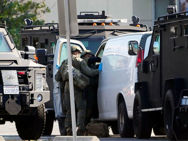 Members of a SWAT team enter a van and look through its contents in Torrance Calif., Sunda