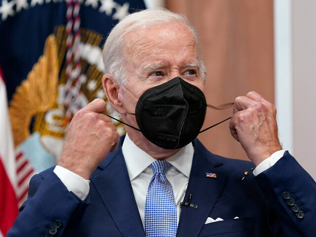 FILE - President Joe Biden removes his face mask as he arrives to speak about the economy during a meeting with CEOs in the South Court Auditorium on the White House complex in Washington, Thursday, July 28, 2022. Biden tested positive for COVID-19 again Saturday, July 30, slightly more than …