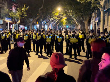 FILE - Chinese police officers block off access to a site where protesters had gathered in Shanghai on Nov. 27, 2022. What started as an unplanned vigil last weekend in Shanghai by fewer than a dozen people grew hours later into a rowdy crowd of hundreds. The protesters expressed anger …