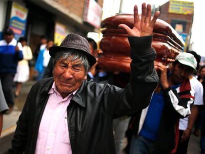 People attend the funeral procession of John Mendoza, who was killed during protests against new President Dina Boluarte, in Ayacucho, Peru, Saturday, Dec. 17, 2022. Peru’s new government declared a national emergency as it struggled to calm violent protests over President Pedro Castillo’s ouster, suspending the rights of “personal security …
