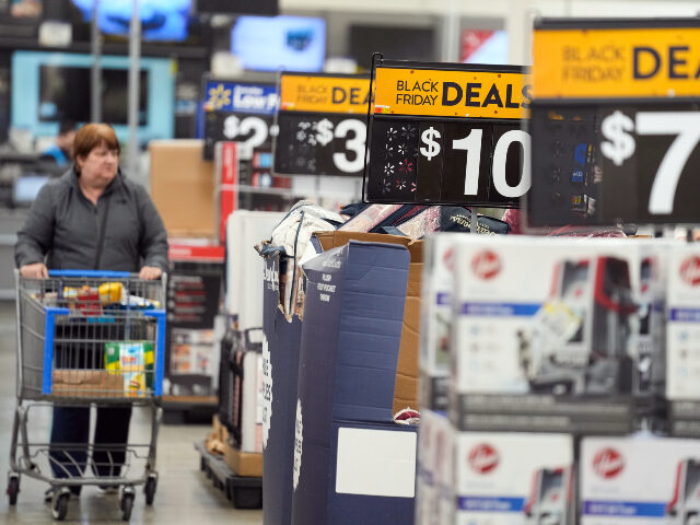 FILE - Signs advertise Black Friday deals at a Walmart in Secaucus, N.J., Nov. 22, 2022. A