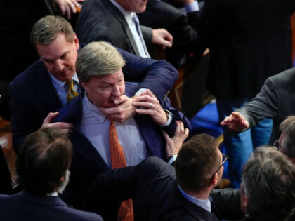 Rep. Richard Hudson, R-N.C., left, pulls Rep. Mike Rogers, R-Ala., back as they talk with