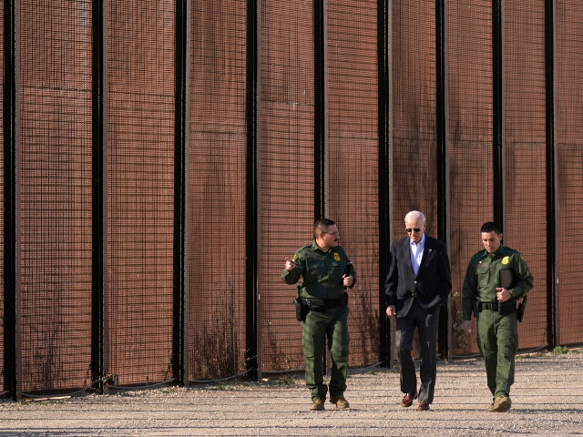 President Joe Biden walks with U.S. Border Patrol agents along a stretch of the U.S.-Mexic