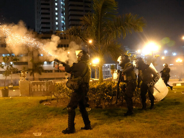Riot police fire tear gas at anti-government protesters in Lima, Peru, Friday, Jan. 20, 20