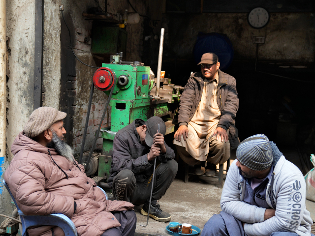 Workers wait for electricity outside their workshop following a power breakdown across the country, in Lahore, Pakistan, Monday, Jan. 23, 2023. Much of Pakistan was left without power for several hours on Monday morning as an energy-saving measure by the government backfired. The outage spread panic and raised questions about the cash-strapped government’s handling of the crisis. (AP Photo/K.M. Chaudary)