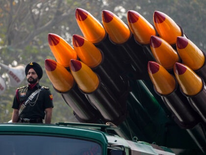 An Indian army soldier stands next to 300mm SMERCH MLRS as it rolls past the saluting base