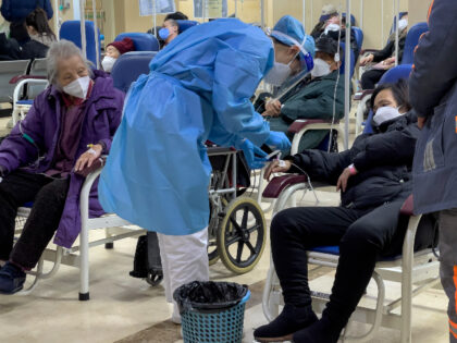 An elderly patient watches a medical worker check on a woman as they receive intravenous drips in an emergency ward in Beijing, Thursday, Jan. 19, 2023. China on Thursday accused "some Western media" of bias, smears and political manipulation in their coverage of China's abrupt ending of its strict "zero-COVID" …