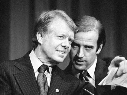 FILE - In this Feb. 20, 1978, file photo, President Jimmy Carter listens to Sen. Joseph R. Biden, D-Del., as they wait to speak at fund raising reception at Padua Academy in Wilmington, Del. (AP Photo/Barry Thumma, File)