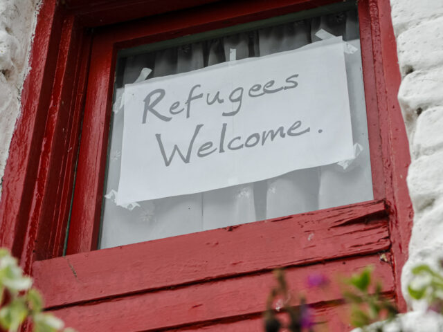 Sign on a window saying Refugees Welcome