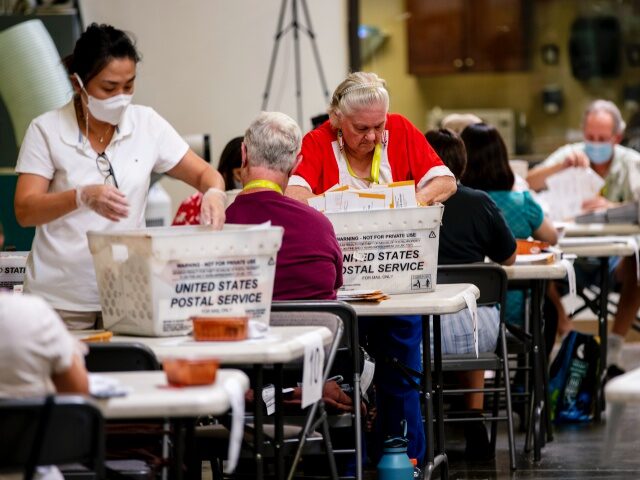 SANTA ANA, CA - September 14, 2021: Election workers organize incoming ballots on the day