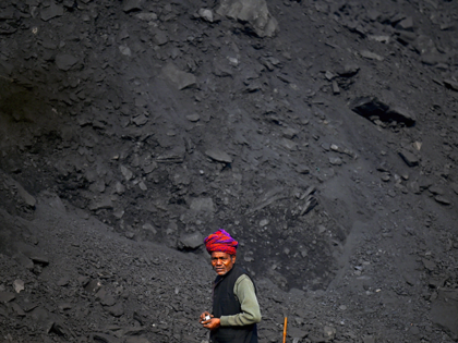 A labourer watches while working in a coal yard at Singrauli in India's Madhya Pradesh state on November 18, 2021. (Photo by Money SHARMA / AFP) (Photo by MONEY SHARMA/AFP via Getty Images)