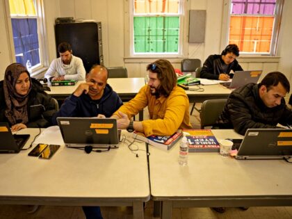 BLACKSTONE, VA - DECEMBER 16: Afghan medical doctors study for American licensure in the computer lab at an Afghan refugee camp at Fort Pickett on December 16, 2021 in Blackstone, Virginia. Fort Pickett normally operates as an Army National Guard maneuver training center, but converted its capabilities to house up …